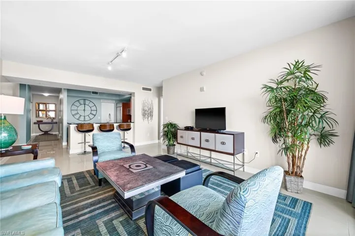 Living area featuring tile patterned floors and rail lighting