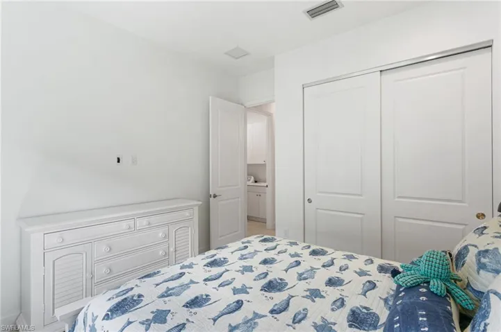 Interior room featuring white walls, a white paneled sliding closet door, and a white interior door