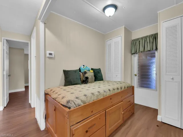 Bedroom featuring light hardwood / wood-style floors and multiple closets
