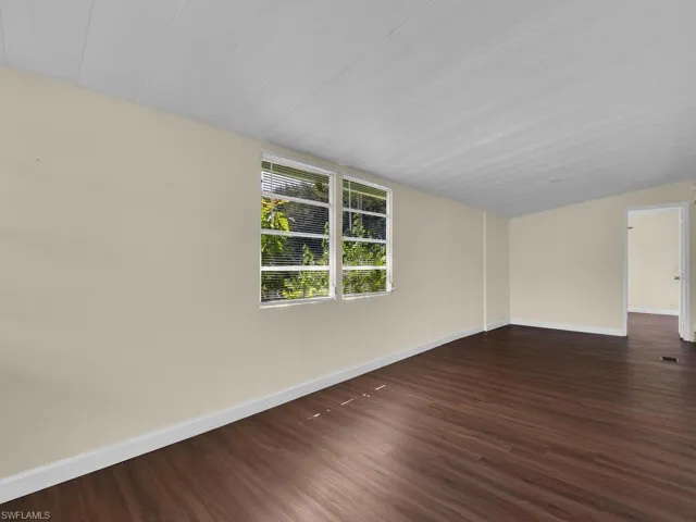 Unfurnished room featuring dark wood-type flooring