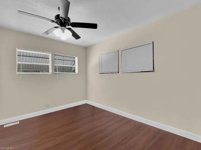 Unfurnished room featuring ceiling fan and hardwood / wood-style floors