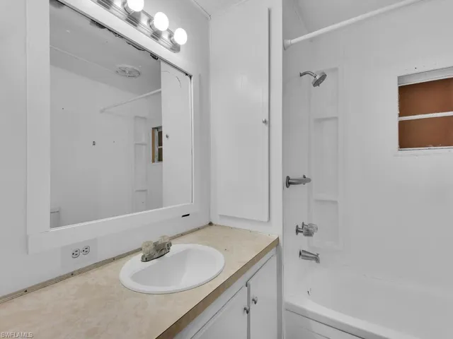 Bathroom with vanity and bathing tub / shower combination