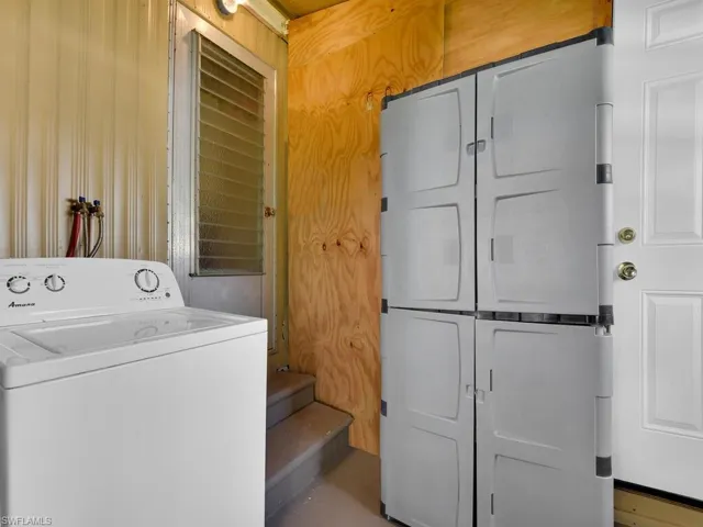 Laundry area featuring washer / clothes dryer and cabinets
