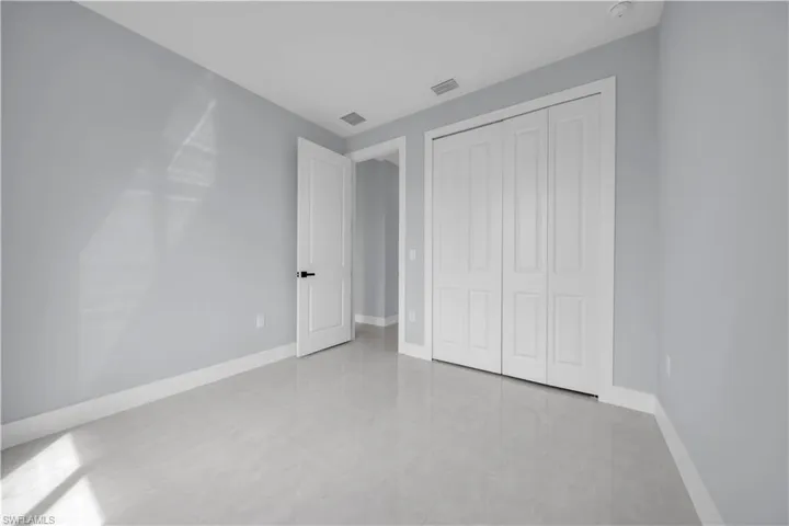 Light grey walls, white trim, and bi-fold closet doors