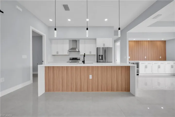 Modern kitchen island featuring a wood-finish slatted facade and white countertop