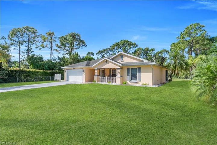Single story home with concrete driveway, a garage, and stucco siding
