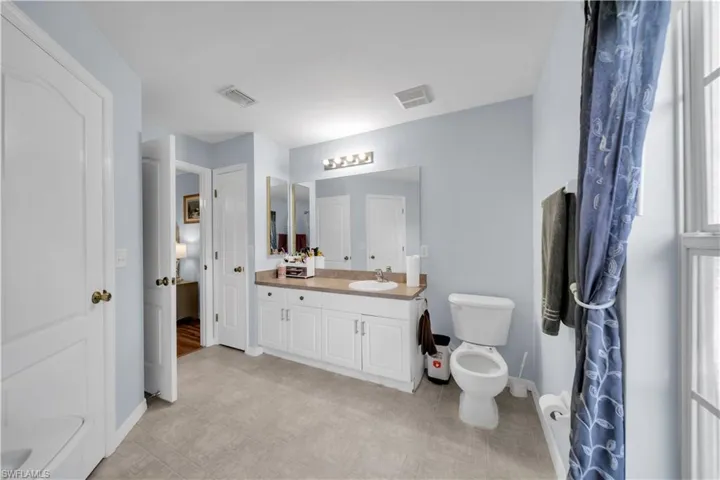 Bathroom featuring vanity and toilet