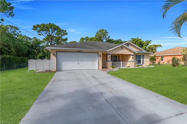 Single story home with stucco siding, a garage, and concrete driveway
