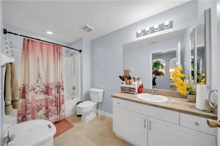 Bathroom featuring shower / bath combo, vanity, recessed lighting, and light tile patterned flooring
