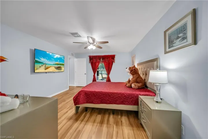 Bedroom with light wood-style floors and a ceiling fan