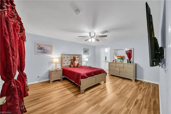 Bedroom with light wood finished floors and ceiling fan