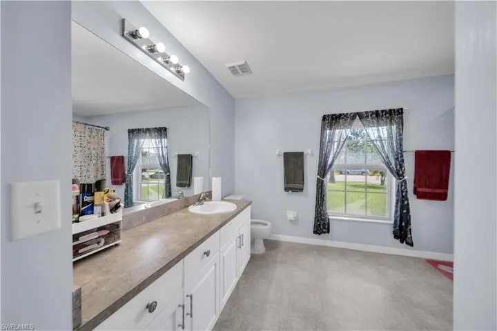 Bathroom with vanity and baseboards
