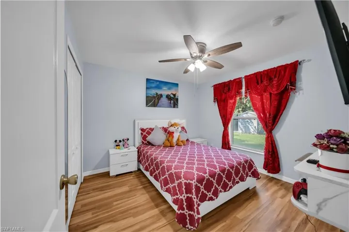 Bedroom featuring light wood-style flooring, a closet, and ceiling fan