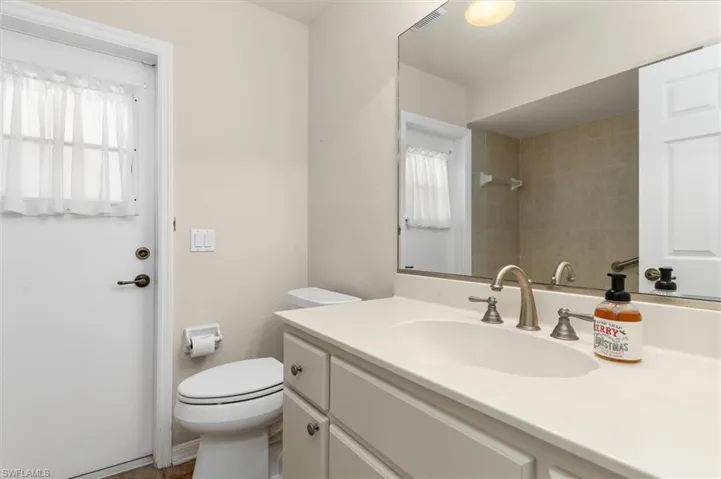 Bathroom with a healthy amount of sunlight, vanity, and toilet