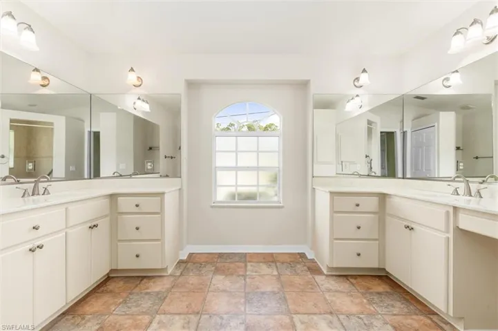 Bathroom with vinyl patterned floors and dual bowl vanity