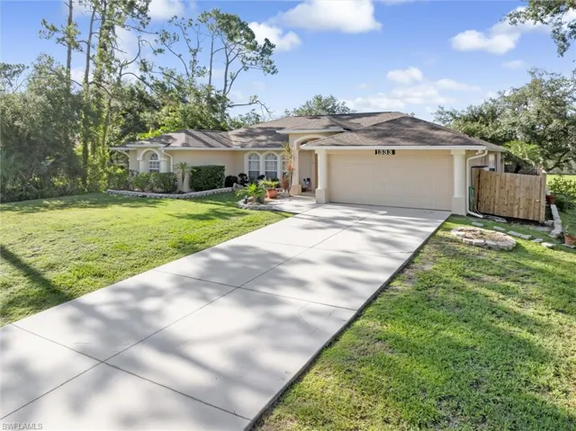 Ranch-style home featuring a garage and a front yard