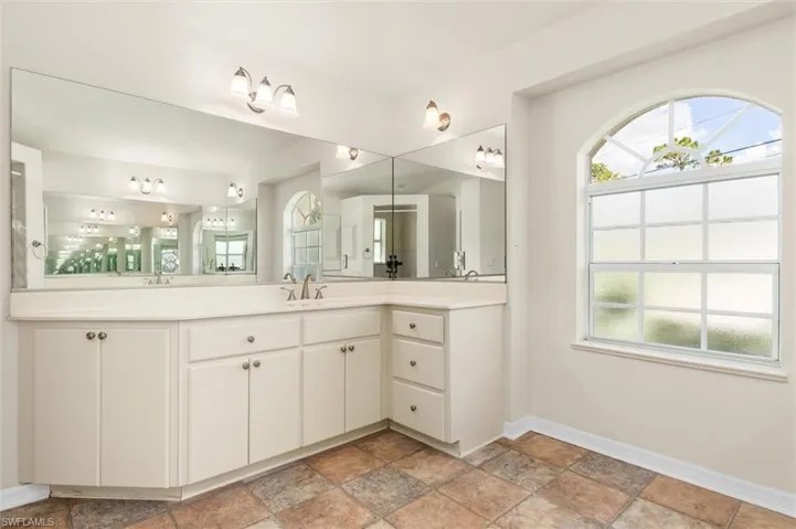 Bathroom with vinyl patterned floors and dual bowl vanity