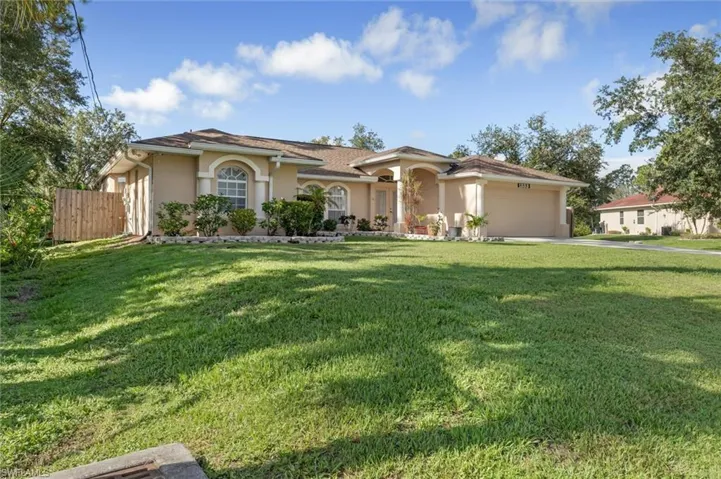 Mediterranean / spanish-style home with a garage and a front yard