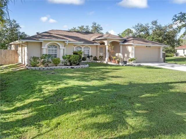 View of front facade with a garage and a front yard