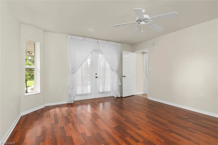 Master bedroom w/wood-style floors and ceiling fan