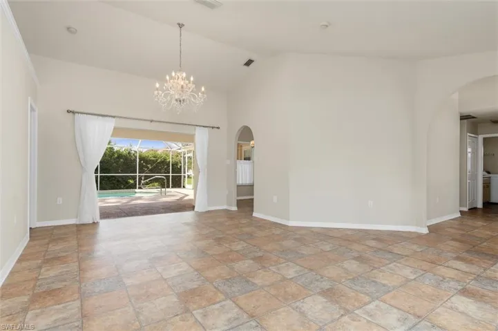 Living room featuring high vaulted ceiling and a chandelier
