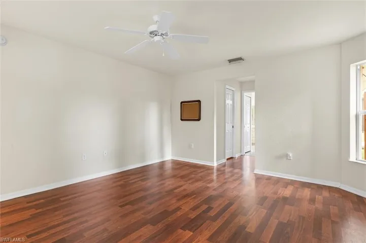 Empty room with wood-style flooring and ceiling fan