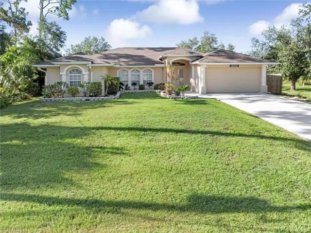 Ranch-style home with a garage and a front yard