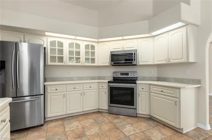 Kitchen featuring light patterned floors and stainless steel appliances