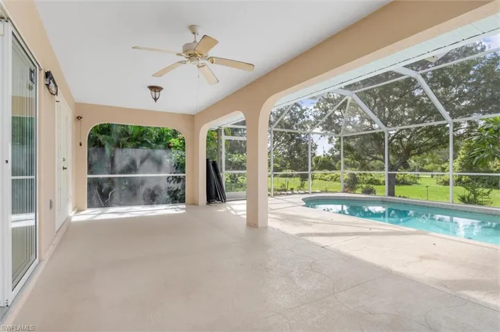 View of swimming pool featuring a lanai, a patio area, and ceiling fan