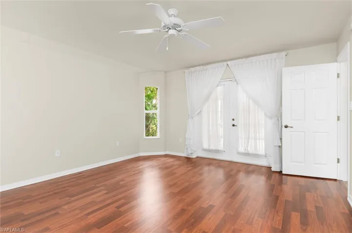 Unfurnished room featuring wood-style floors and ceiling fan