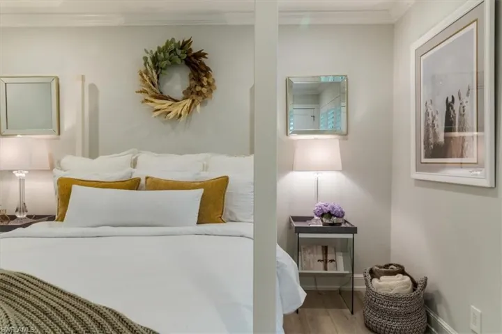 Bedroom featuring hardwood / wood-style floors and crown molding