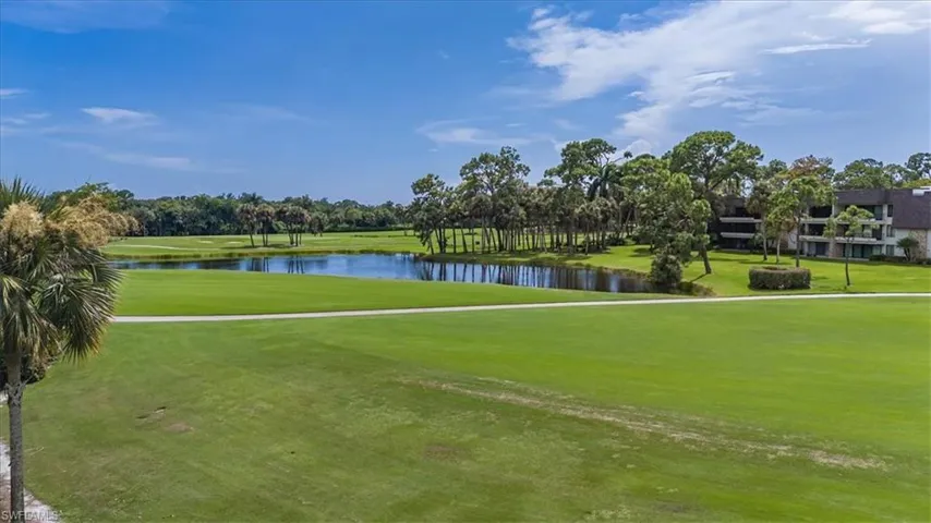 View of property's community featuring a water view and a lawn