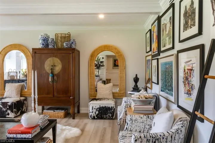 Sitting room featuring crown molding and light hardwood / wood-style flooring