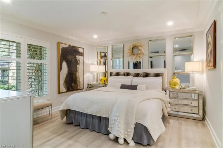Bedroom with crown molding and light hardwood / wood-style floors