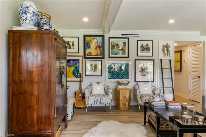 Sitting room featuring light wood-type flooring and crown molding
