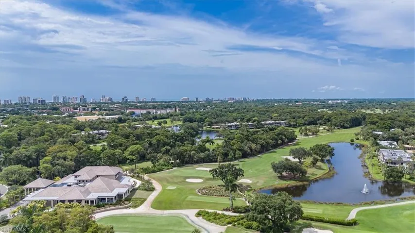 Birds eye view of property with a water view
