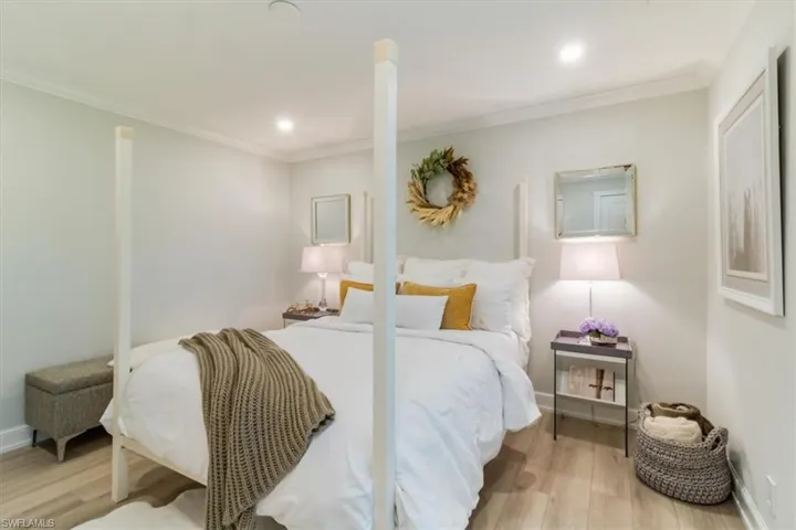 Bedroom with ornamental molding and light wood-type flooring