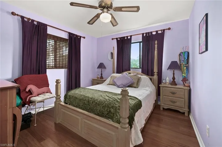 Bedroom with wood finished floors, baseboards, and a ceiling fan