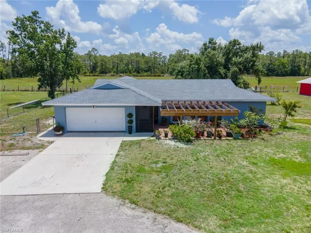 View of front of property with a garage and driveway