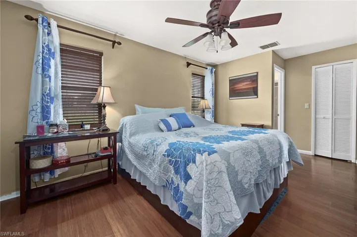 Bedroom with wood finished floors, baseboards, and ceiling fan