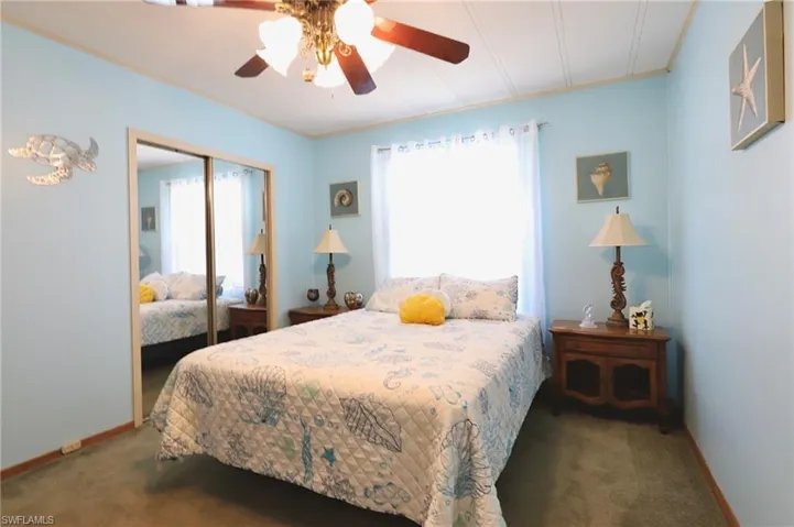 Bedroom featuring carpet, ceiling fan, and a closet