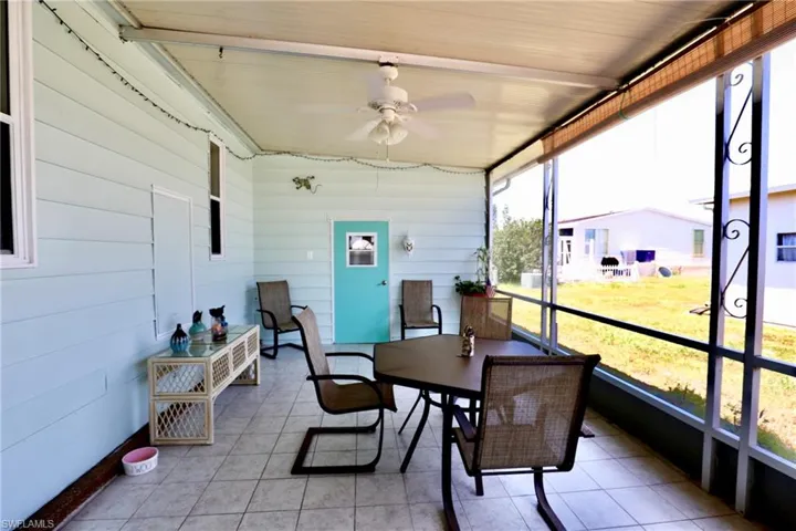 Sunroom / solarium with ceiling fan and wood ceiling