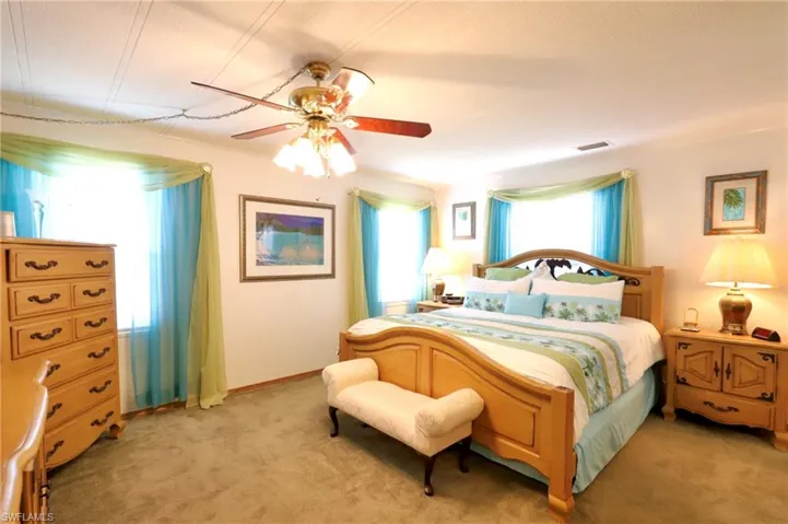 Carpeted bedroom with ceiling fan