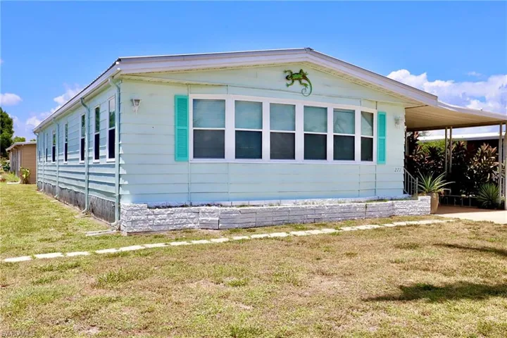 View of side of home with a yard