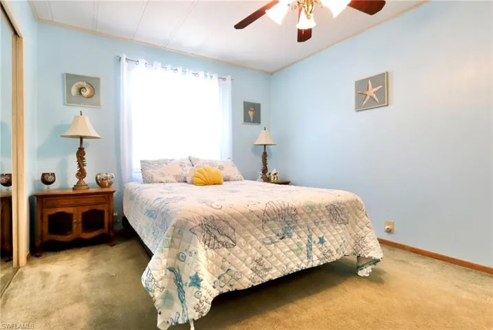 Bedroom with ceiling fan and carpet floors