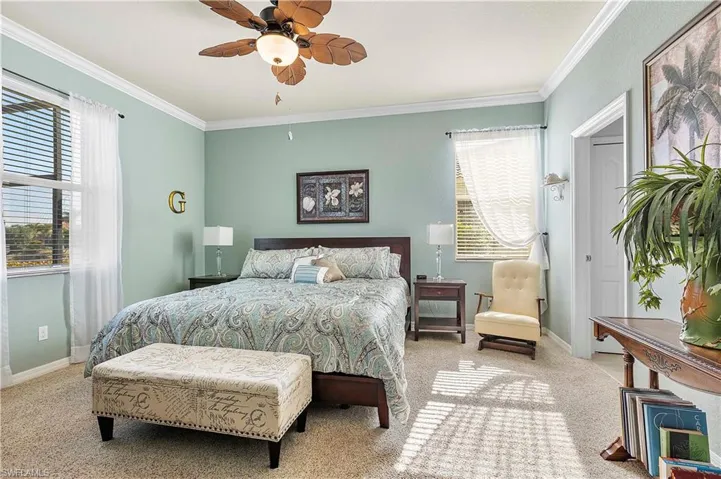 Main bedroom featuring ceiling fan and crown molding