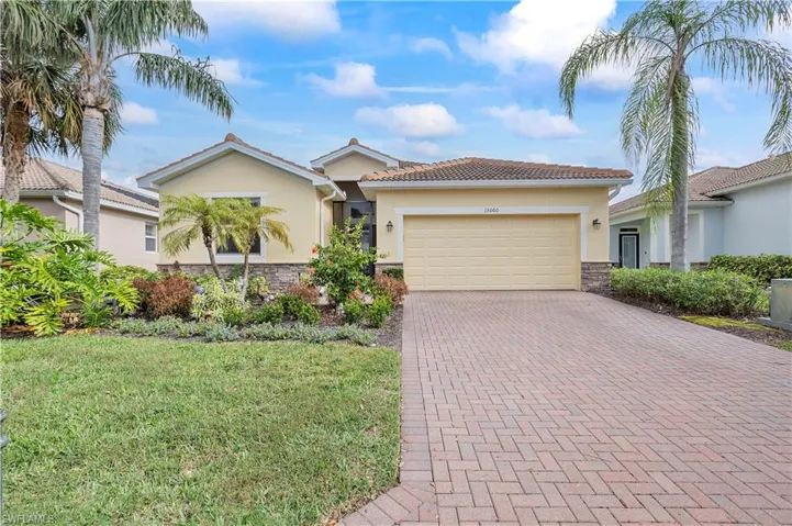 View of front of house with a front lawn and a garage