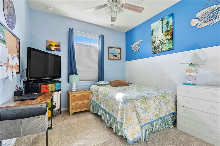 Bedroom featuring ceiling fan and light carpet