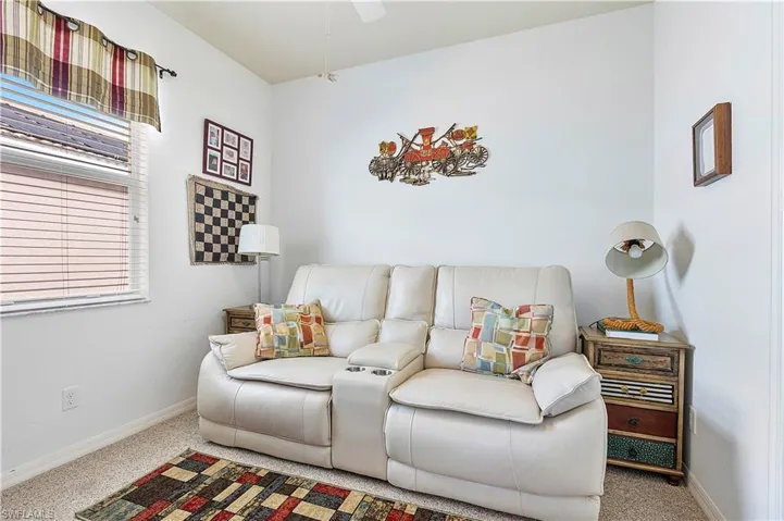 Living room with carpet flooring and a healthy amount of sunlight