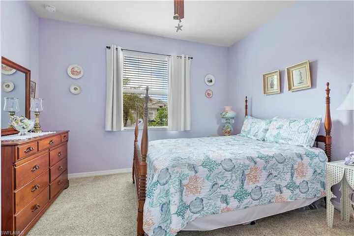 Bedroom with light colored carpet and ceiling fan